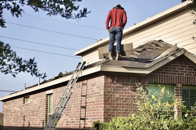 Professional roofer working on a residential roof in Conyers